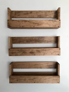 three wooden shelves are hanging on the wall