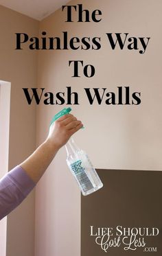 a person holding a plastic bottle with the words the painless way to wash walls