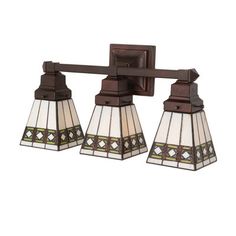 three light bathroom fixture with stained glass shades on the top and bottom lights in bronze finish