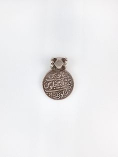 "A truly special antique Indian devotional charm worn during Islamic pilgrimages.  measurements: 1\" circumference  material: 800 silver  circa: 1920s" Collectible Traditional Jewelry In Antique Silver, Antique Silver Jewelry For Ceremonial Occasions, Antique Silver Jewelry For Ceremonies, Sterling Silver Round Jewelry For Rituals, Antique Silver Jewelry With Vintage Charm Pendant, Antique Silver Jewelry With Vintage Charm Round Pendant, Antique Silver Round Jewelry, Spiritual Silver Jewelry With Coin Pendant, Traditional Necklaces With Vintage Charm And Round Pendant