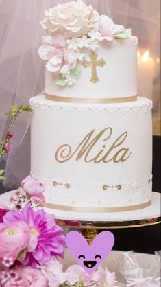 a wedding cake with flowers and a cross on top