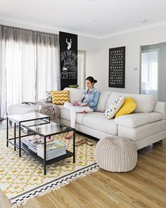 a woman sitting on top of a couch in a living room