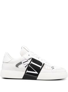 VL7N low-top sneakers from VALENTINO GARAVANI featuring white/black, calf leather, round toe, front lace-up fastening, perforated embellishment, logo-print strap, pull-tab at the tongue and flat sole. White Calf Leather Sneakers With Embossed Logo, Custom Low-top Calf Leather Sneakers With Embossed Logo, Low-top Custom Sneakers With Embossed Logo In Calf Leather, White Low-top Custom Sneakers With Embossed Logo, Designer White Sneakers With Embossed Logo, Designer White Sneakers With Logo, Luxury White High-top Sneakers With Embossed Logo, Designer Low-top Sneakers With Logo Detail, Designer White Calf Leather Sneakers