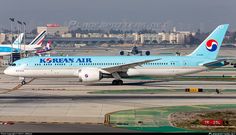 two korean air planes are parked on the tarmac at an airport in front of other airplanes