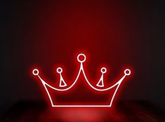 a red neon sign with a crown on it's side in the middle of a dark room