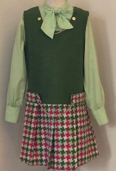 "Labeled size 12/true vintage run small/60s Dress/Jumper with olive woven top & multicolored styolized hounds tooth pleated skirt(one piece dress). Goldtone chain links and embossed button accents/back metal zipper/Apple green button down blouse with neck bowtie. 3 button sleeve cuffs / smoke free environment / jumper - (pit to pit ) 14 1/2\"/ waist 14 1/2\"/ hips 15 1/2\"/ length (shoulder to bottom) 28\"/blouse-pit to pit 15 1/4\"/ pit to wrist 15\"/ length (shoulder to bottom) 16 1/2\"/good c 60s Green Outfit, Vintage School Uniform, Vintage Collared Mini Dress, Quirky Fashion Vintage, 1960s Glam, 60s Tweed Dress, Green 60s Dress, Vintage Green Collared Dress