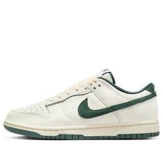 The Nike Dunk Low Athletic Department Deep Jungle, part of the nostalgic Athletic Department Pack, features a white base with dark green accents.  The smooth leather upper contrasts with suede Swooshes and details, creating a vintage look.  Minimal branding and an off-white midsole add to the retro feel.  Released on October 1, 2023, this limited-edition sneaker retails for $110. 90s Nike Shoes, Sneakers Fashion Mens, Grad Shoes, Podcast Marketing, Deep Jungle, Nike Air Jordan Shoes, Limited Edition Sneakers, Dunks Nike, Jungle Green