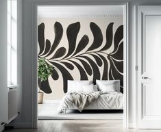 an open door leading to a bedroom with a large wall mural