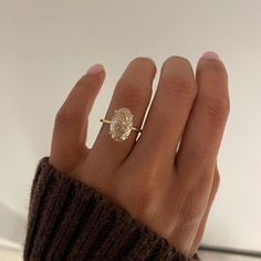 a woman's hand with a diamond ring on it