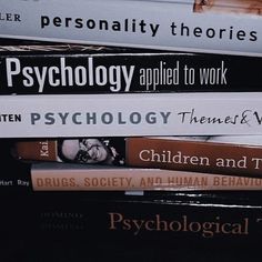 a stack of books sitting on top of each other in front of a black background