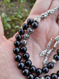 ✔️ This is a 33 pcs magnificent personalized rosary made of AAA quality 8 mm black onyx beads. ✔️ It is a customized elegant and striking tasbih gift for Men. ✔️ Each order comes in a special box. ✔️ PLEASE CLICK THE LINK FOR ALL PRAYER BEADS MODELS https://www.etsy.com/shop/GoodJewelsofYazmasal Note: As a natural feature the stones beads may have some variations. SHIPPING: United States (Standart/DHL eCommerce/usps): 7-10 business days United States (Express/FedEx): 3-5 business days Canada (Ex Onyx Black Beads For Gifts, Handmade Black Spiritual Beads, Black Hand-strung Beads As Gift, Gift Hand-strung Black Beads, Handmade Spiritual Black Beads, Black Hand-strung Beads Gift, Traditional Black Beaded Bracelets As Gift, Black 8mm Beads For Gifts, Traditional Black Bracelet With Gemstone Beads