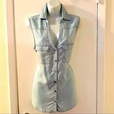 This Sleeveless Shirt Is A Feminine Take On The Classic Denim Top, And It’s Exactly What Your Closet Needs. Light Wash Soft Denim Sleeveless Button-Down With White Stars Along Front And Back Shoulder Area. Color: Light Wash Size: L Measurements: Approx 21” Across Chest And 28” From Shoulder To Hem. Condition: Brand New With Tags Summer Chambray Collared Denim Top, Fitted Sleeveless Light Wash Denim Top, Washed Blue Button-up Denim Vest For Summer, Light Wash Fitted Sleeveless Denim Vest, Fitted Light Wash Denim Sleeveless Vest, Fitted Light Wash Sleeveless Denim Vest, Trendy Washed Blue Sleeveless Tank Top, Trendy Sleeveless Top With Pockets, Summer Light Wash Denim Top With Pockets