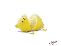 two lemons with faces drawn on them sitting side by side in front of each other