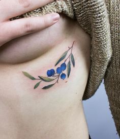 a woman's stomach with blue berries on it