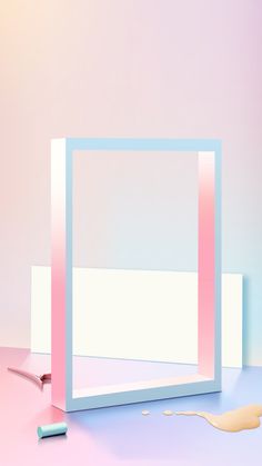 a pink and blue frame sitting on top of a table next to a toothbrush