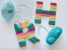 yarn and yarnsticks laid out to make the letter h for crafting with yarn