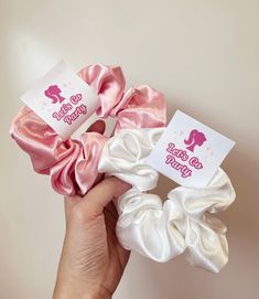 three scrunchy hair ties in pink and white, one with an elephant on it