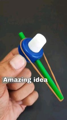 a hand holding two toothbrushes with the words amazing idea written on one side