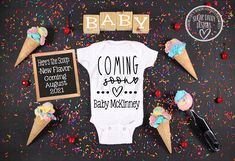 a baby announcement with ice cream cones and sprinkles on the ground next to it