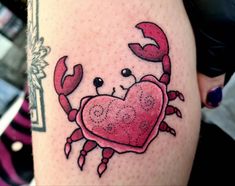 a crab with a heart tattoo on its arm