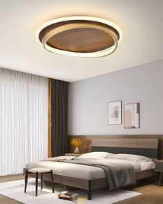 a bed room with a neatly made bed and a round light above the headboard