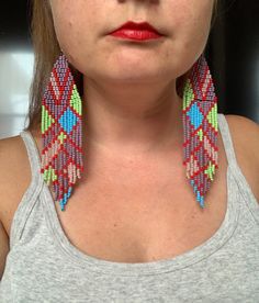 a close up of a person wearing some kind of colorful earring on their head