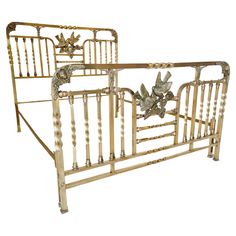 a gold metal bed frame with birds on it