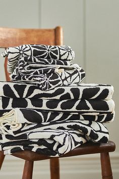 a stack of towels sitting on top of a wooden chair