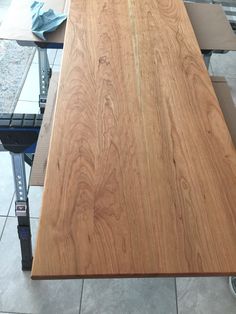 a wooden table sitting on top of a tiled floor