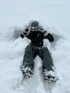 a person laying in the snow with their feet up