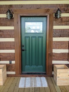 a green door and some wooden benches on a porch