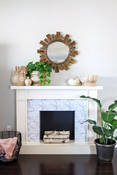 a living room with a fireplace, mirror and potted plants