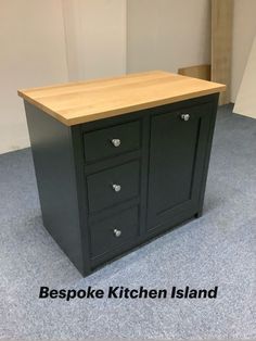 a black kitchen island with two drawers on one side and an open drawer on the other