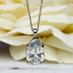 "The pendant pictured is a simulated diamond #6998 Also available with moissanite - please message us for pricing. -Approximate total carat weight: approx. 3.60ctw diamond equivalent -Center Stone Size: 12x8mm - approx. 3.60ct diamond equivalent -Center Stone Shape: pear / tear drop -Gem Type: simulated diamond -Stone Clarity: VVS1 -Stone Color: D -Moh's Scale: 8.5 hardness -Metal Type and Purity: 14k white gold -Setting: 5 prong basket head -Chain: delicate 14k gold chain / heavier option with Pear Shape Pendant, Pear Shaped Pendant, Solitaire Necklace, Head Chain, Necklace Bridal, White Gold Set, Solitaire Necklaces, Necklace Simple, Teardrop Necklace