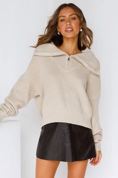 Length from shoulder to hem of size S/M: 53cm. Beige knit top. Non-lined. Cold hand wash only. Model is a standard XS and is wearing XS. True to size. Stretchy, soft ribbed, knit fabric. No zipper. Slip-on style. Cotton/ Acrylic. Looking for a cosy knit, that's simple but an extra touch! The Hung Up Knit is the way to go. This stunning knit features a loose, relaxed fit with a turtle neck feature, and we can't forget the silver zipper in the turtle neck which makes a whole other look! Wear it how you want. Style with a black leather skirt and white sneakers for a casual cute look. Skirt And White Sneakers, Black Leather Skirt, Ribbed Knit Fabric, Black Leather Skirts, A Turtle, Silver Zipper, Hung Up, Look Casual, White Sneakers