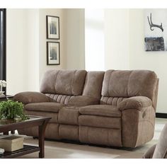 a living room scene with focus on the couch and reclining chair in the center