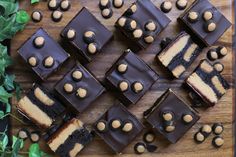 there are many pieces of cake on the cutting board with chocolate and peanut butter toppings