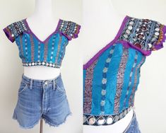 D E T A I L S  - Vintage Indian crop top - So many beautiful details~ embroidery, silk panels, metallic threads, beading, sequins & trim - Open back that ties closed in three places, front is fully lined - Very good condition, may be missing some sequins here and there M E A S U R E M E N T S  - Womens extra small, please see measurements below - Armpit to armpit 18" - Length 13" * to convert inches to centimeters please multiply by 2.54 ** tip: for a sure fit, take a similar item & measure as w Fitted Embroidered Cropped Blouse, Fitted Cropped Embroidered Blouse, Fitted Embroidered Festival Crop Top, Fitted Embroidered Crop Top For Festivals, Fitted Blue Patchwork Blouse, Blue Summer Top With Intricate Embroidery, Embroidered Fitted Bohemian Crop Top, Fitted Embroidered Bohemian Crop Top, Fitted Embroidered Tops For Festival