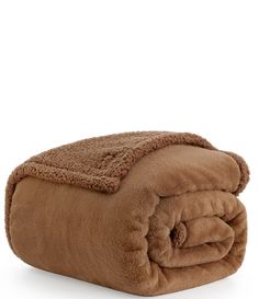 a brown blanket is folded up on a white surface