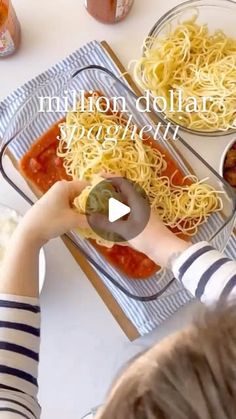 a young boy is making spaghetti with sauce and vegetables on the table in front of him