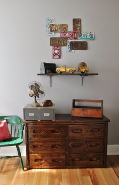 there is a dresser with many items on it in the corner of this living room