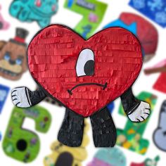 a paper heart with an angry face surrounded by other cut outs