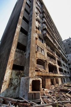 an old, run down building with lots of windows and balconies on it