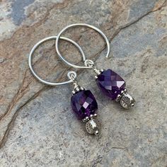 Beautiful deep, dark amethyst earrings! The 8mm faceted amethyst cubes hang from round sterling silver hoop wires with sterling silver flower stamped Hill Tribe silver beads. Your jewelry will arrive in a cotton lined kraft box within a padded postal envelope. I use USPS first class mail. This usually takes 3 to 5 days to ship. International orders outside of the U.S. will take 8 to 15 days to ship. To see more from East Village Jewelry~ http://eastvillagejewelry.etsy.com All orders ship out wit Nickel-free Purple Dangle Hoop Earrings, Purple Nickel-free Dangle Hoop Earrings, Sterling Silver Jewelry With Purple Sterling Silver Clasp, Purple Sterling Silver Jewelry With Silver Clasp, Purple Sterling Silver Jewelry With Sterling Silver Clasp, Adjustable Nickel-free Purple Hoop Earrings, Dark Amethyst, Labradorite Bracelet, Hill Tribe Silver