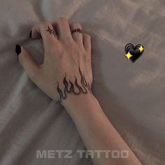 a woman's arm with tattoos on it and a yellow star in the background