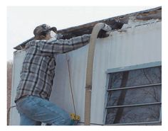 a man working on the side of a building