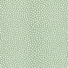 a green background with white polka dots