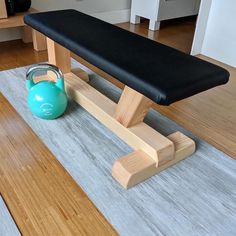 a bench with a kettle on it and a mat in the floor next to it