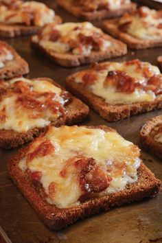 several slices of bread topped with cheese and sauce