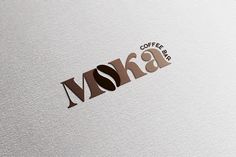 coffee bar logo with the word moka written in brown and black on white paper